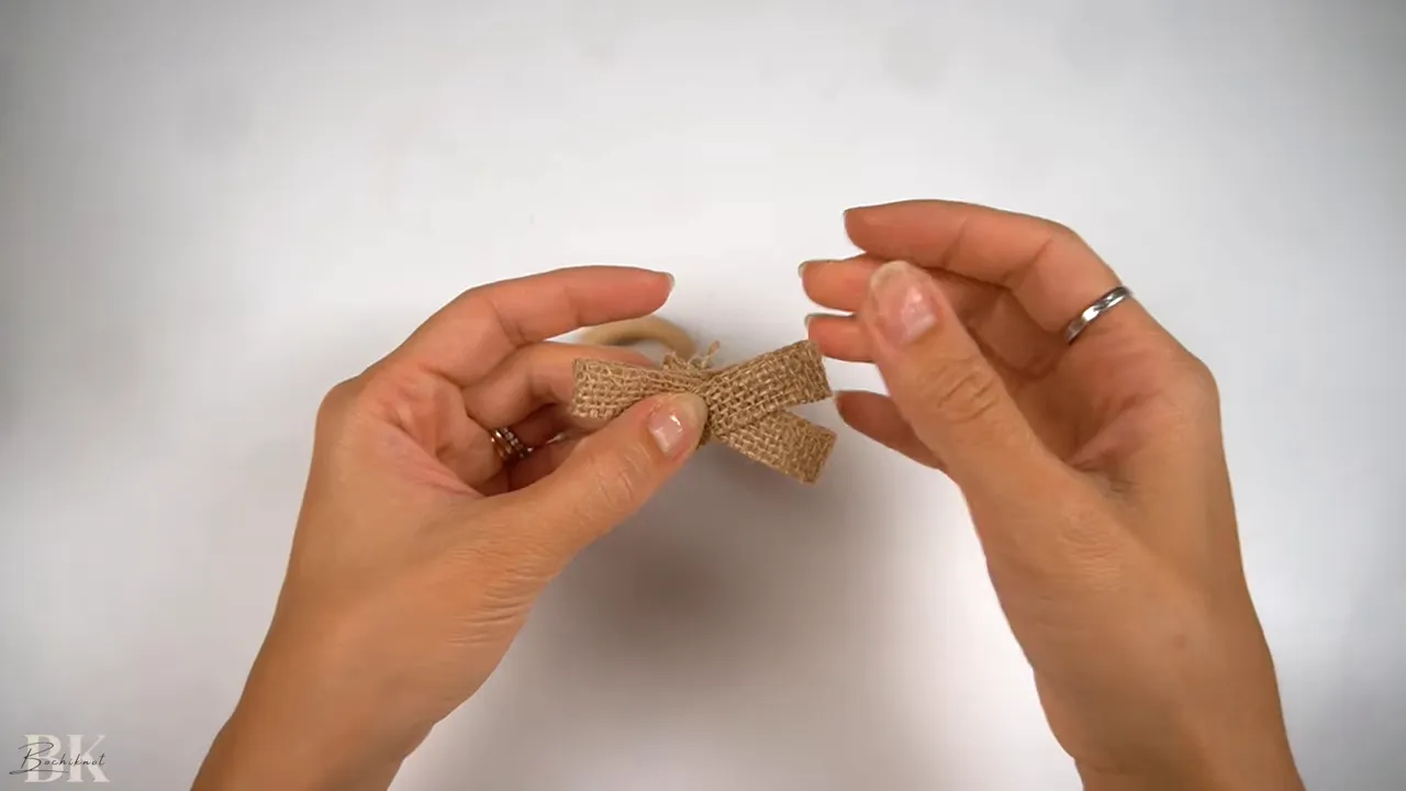 Folding the ribbon into layered loops for the bow