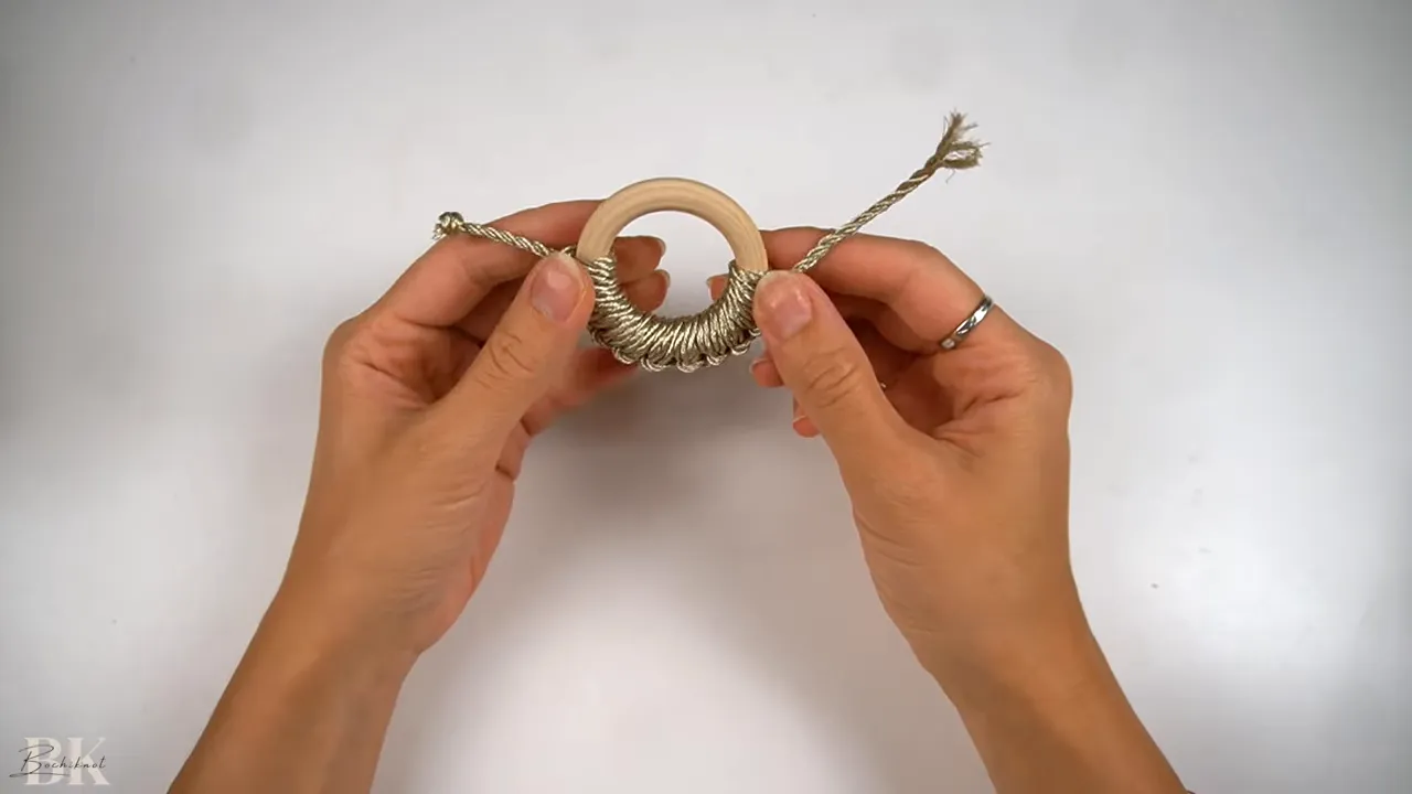 Starting the vertical Lark's Head knots on the wooden ring