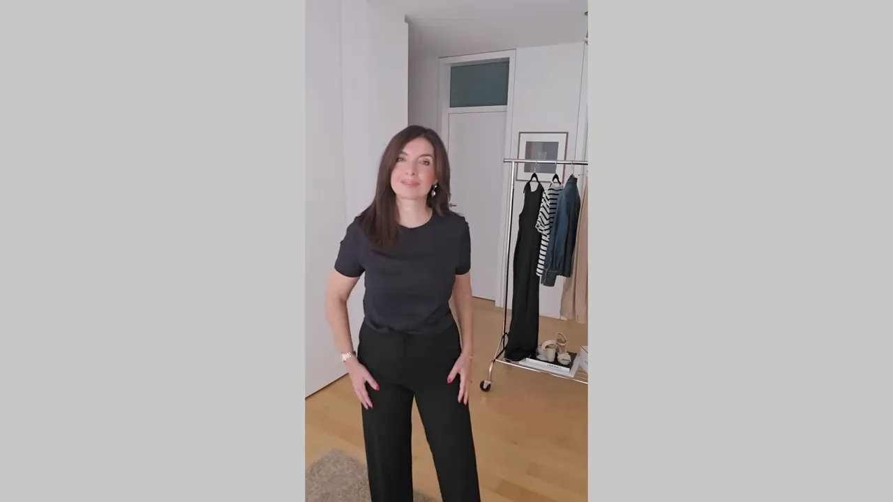 black t-shirt held up in front of camera with woman wearing the same t-shirt in side panel