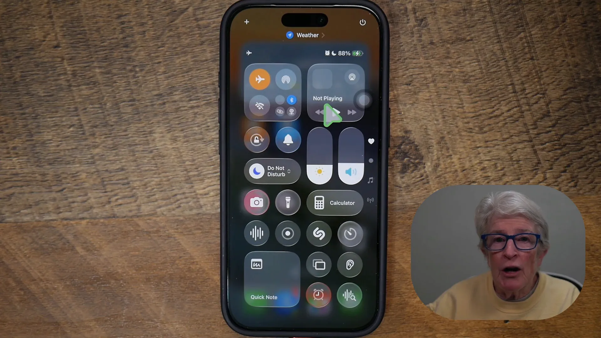 Presenter facing the camera with a neutral expression against a grey background, clear and centered