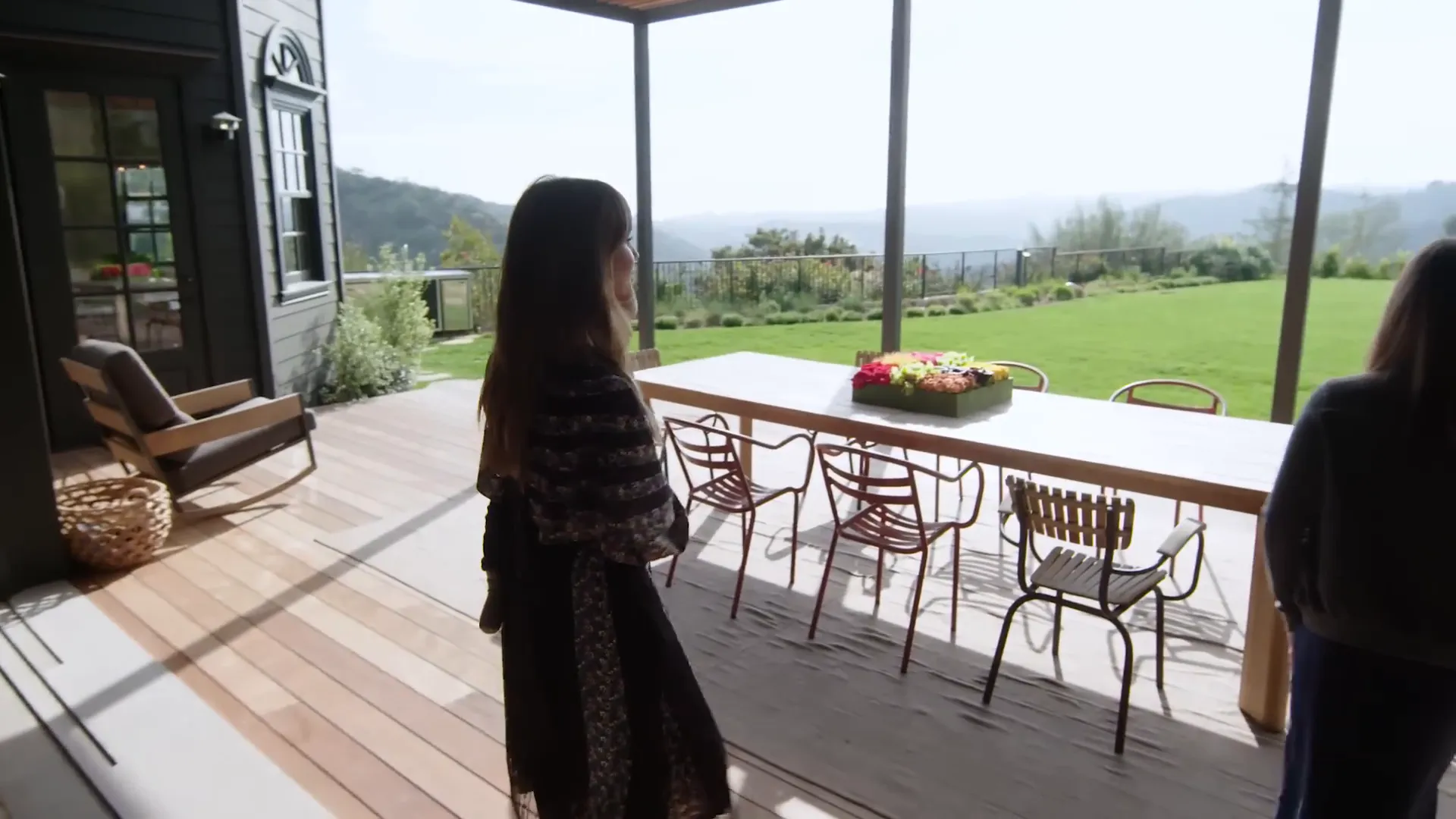 Outdoor dining area with modern table and vintage chairs