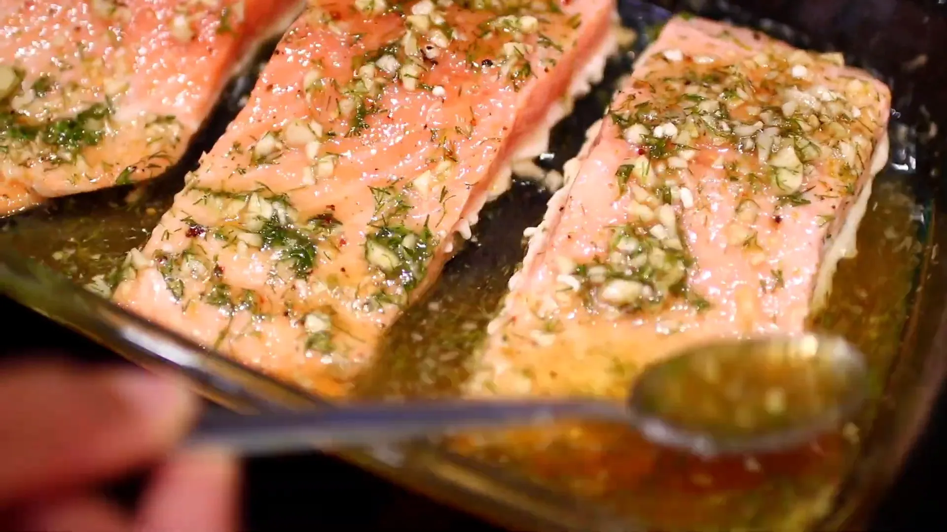 Basting the salmon with marinade after baking