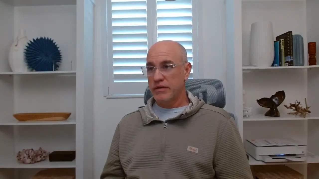 Presenter gesturing with both hands in a home office, clearly explaining server-side tracking and attribution