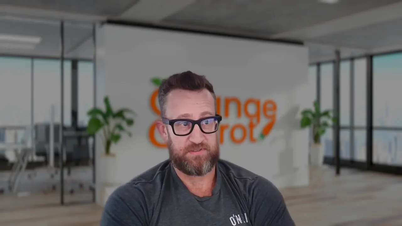 Presenter seated in a home office with shelves and window shutters, explaining cross‑channel marketing strategy