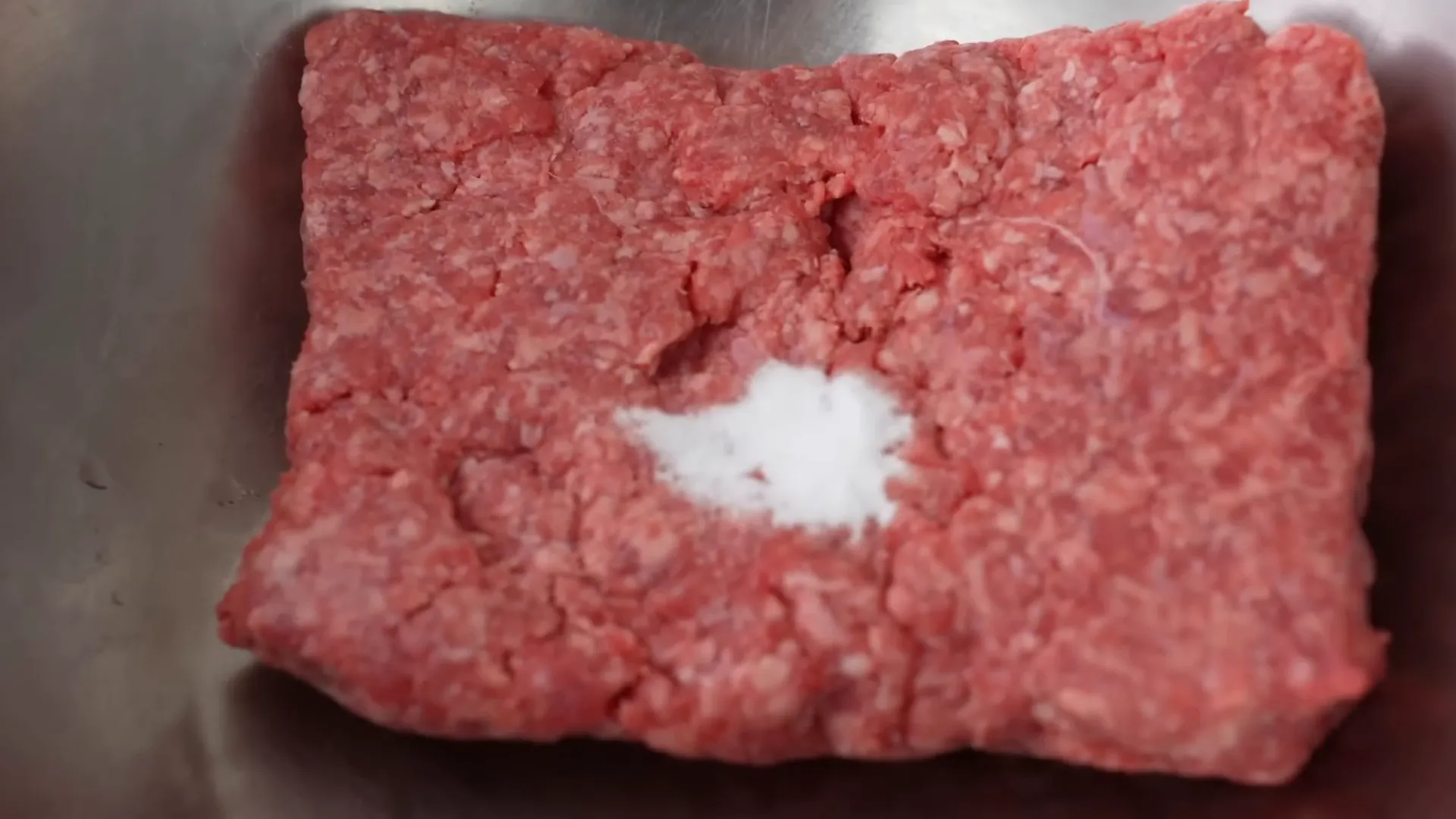 Mixing baking soda into beef