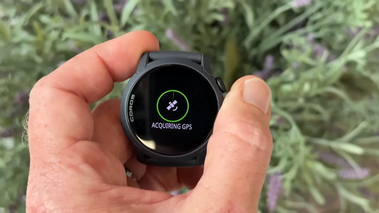 COROS Pace 4 side view showing the action button and AMOLED screen with menu options, finger pointing to the crown