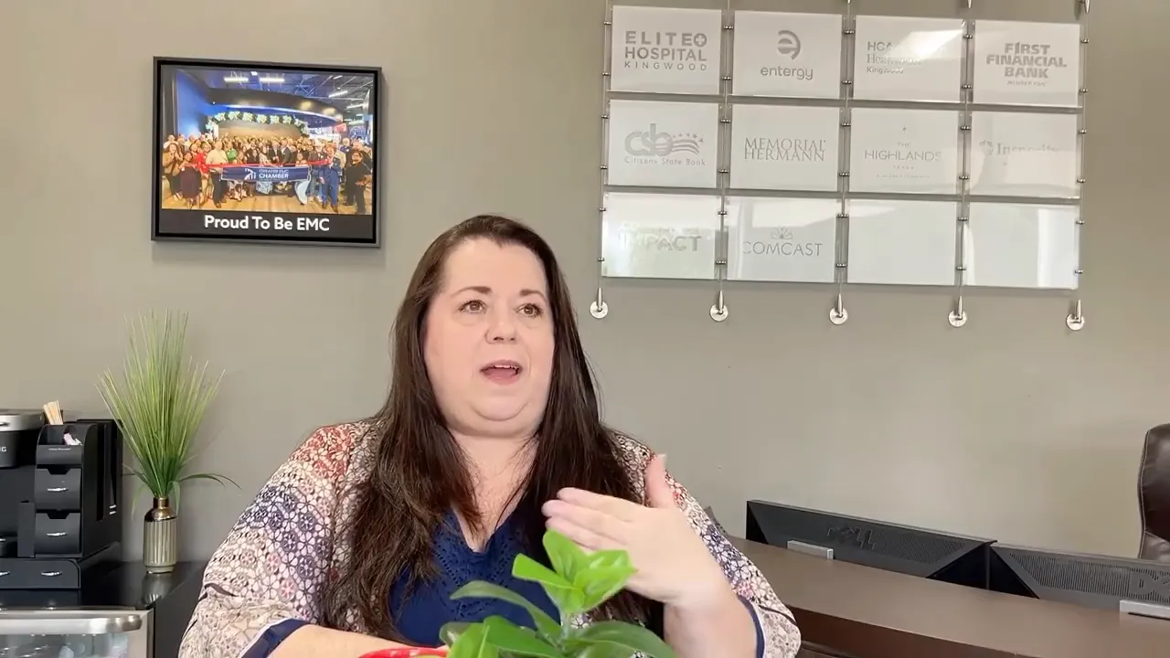 Tracie speaking with Melissa Crabtree across a table in the chamber office