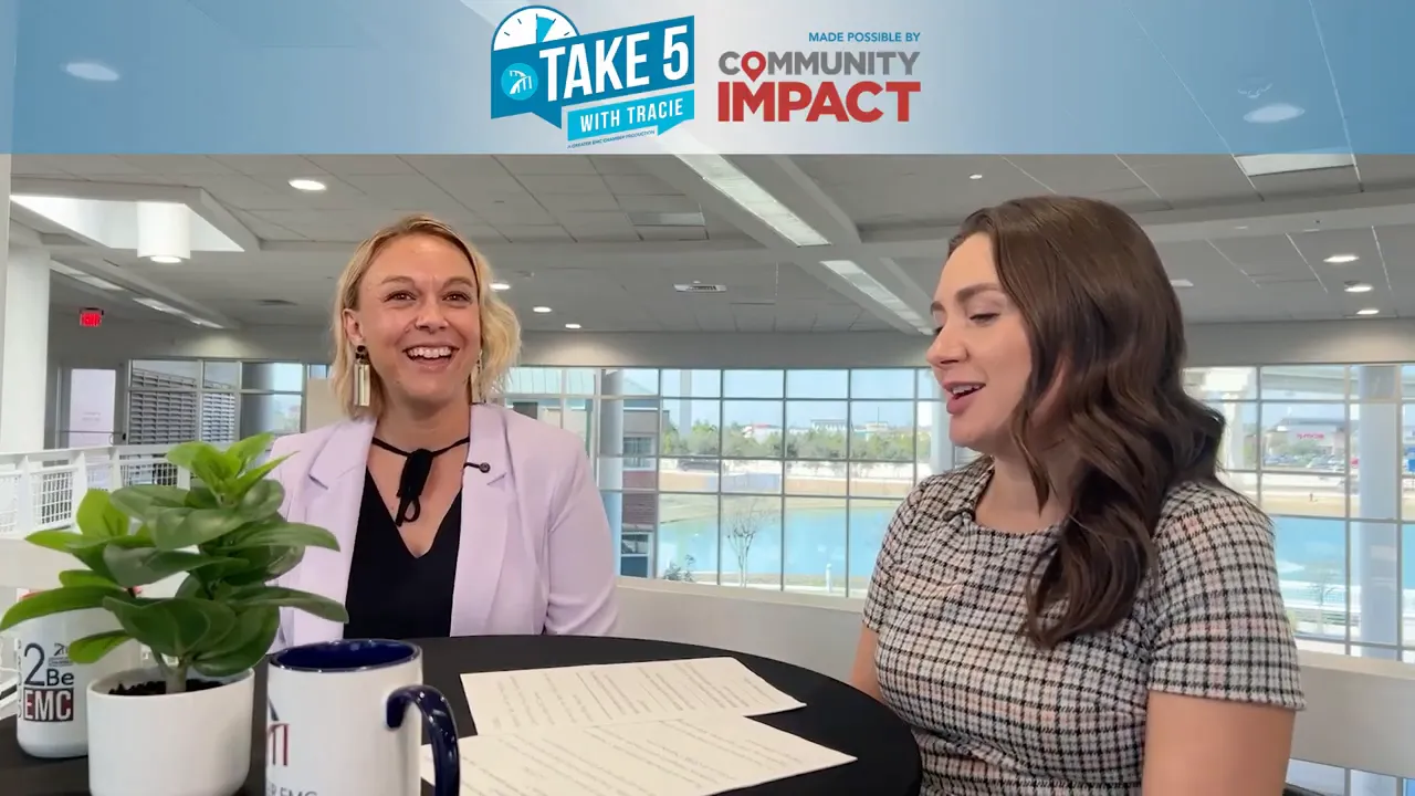 Two women in an interview setting at a round table with visible order sheets, mugs and a plant, discussing timelines