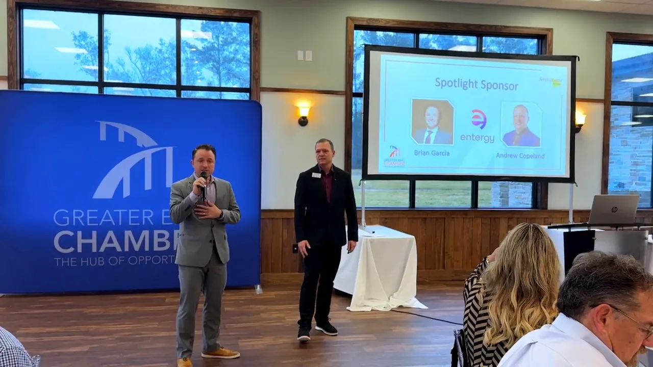 Audience and presenters visible during an Entergy presentation at a Business Networking Breakfast