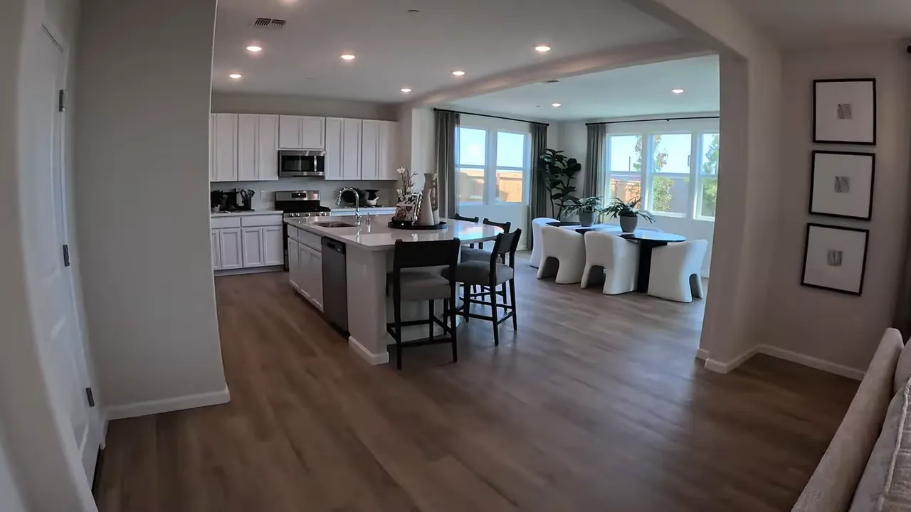 Open concept kitchen with island and stainless steel appliances