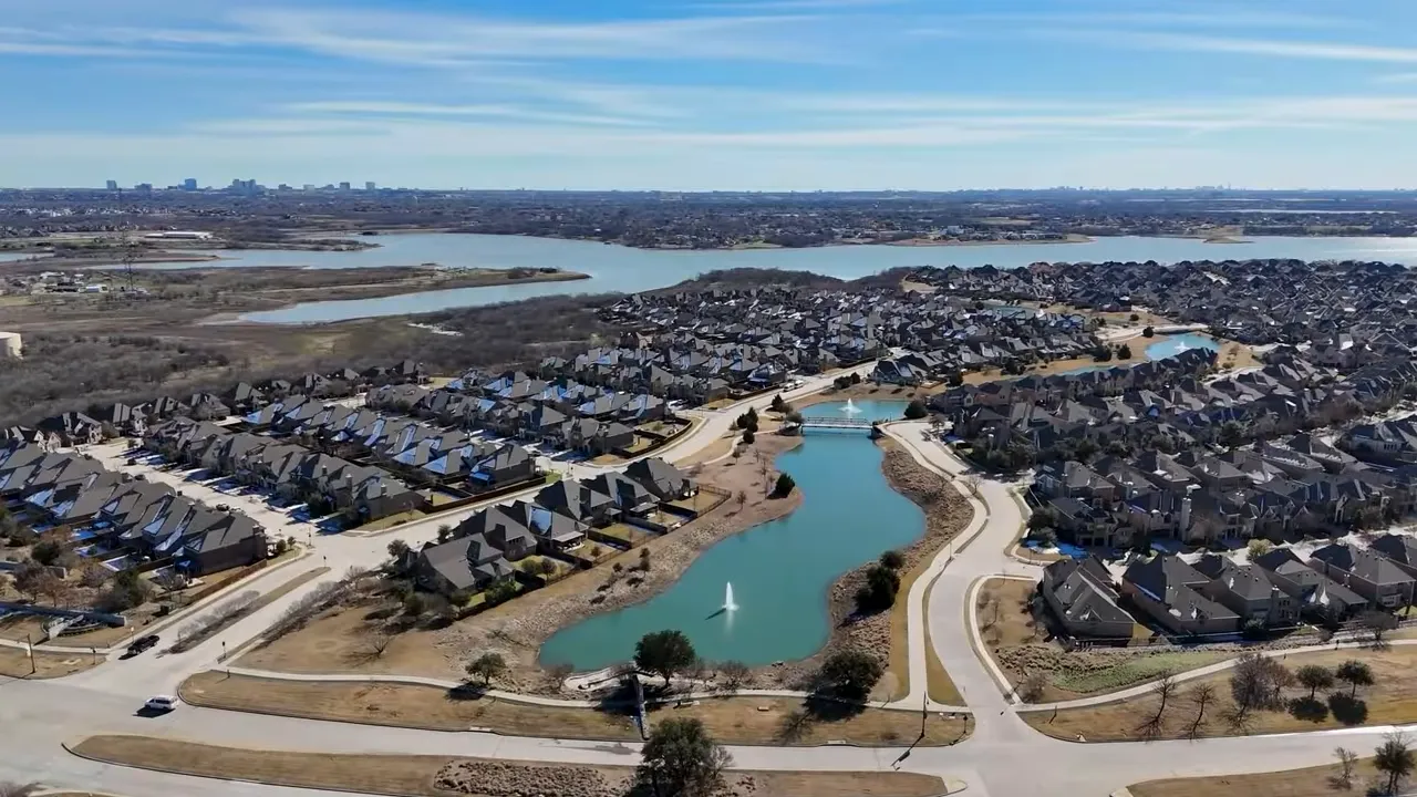 The Tribute community hero image showing a wooden pedestrian bridge over water with 'Find Your Natural Habitat' banner and a small presenter inset