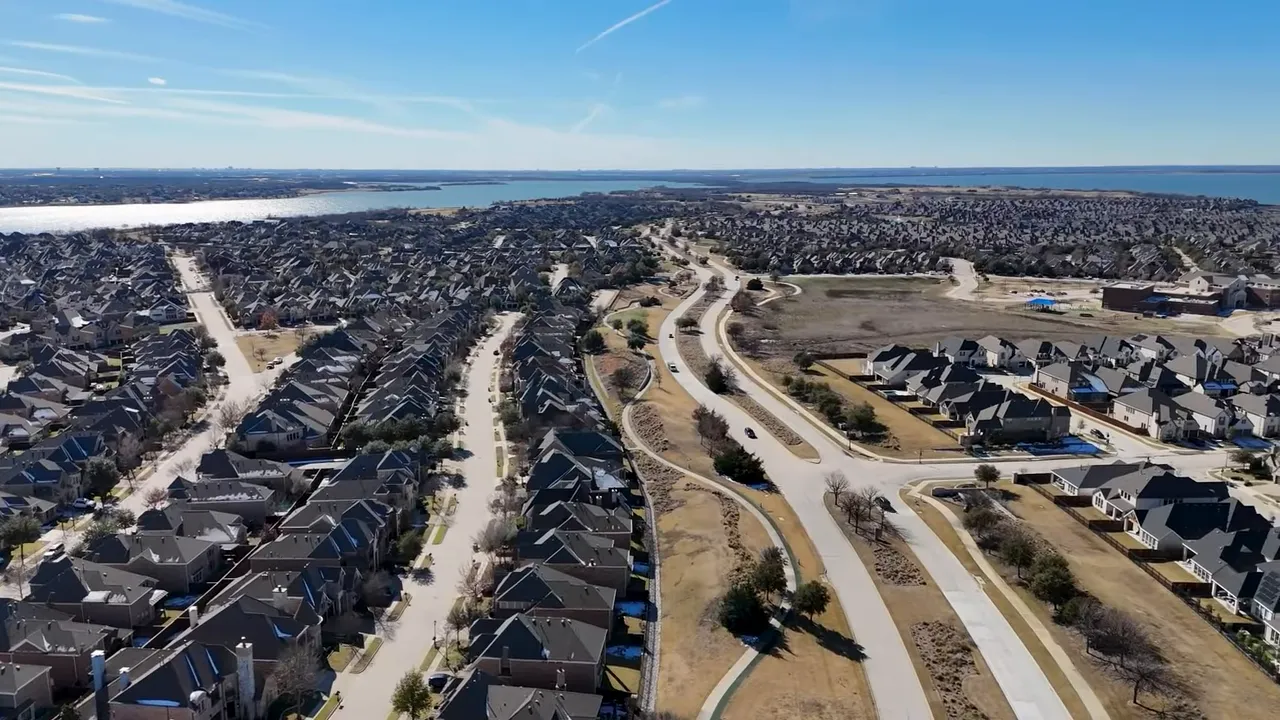 Satellite map of The Tribute at The Colony on Lake Lewisville highlighting peninsula layout, marina, and waterfront neighborhoods.