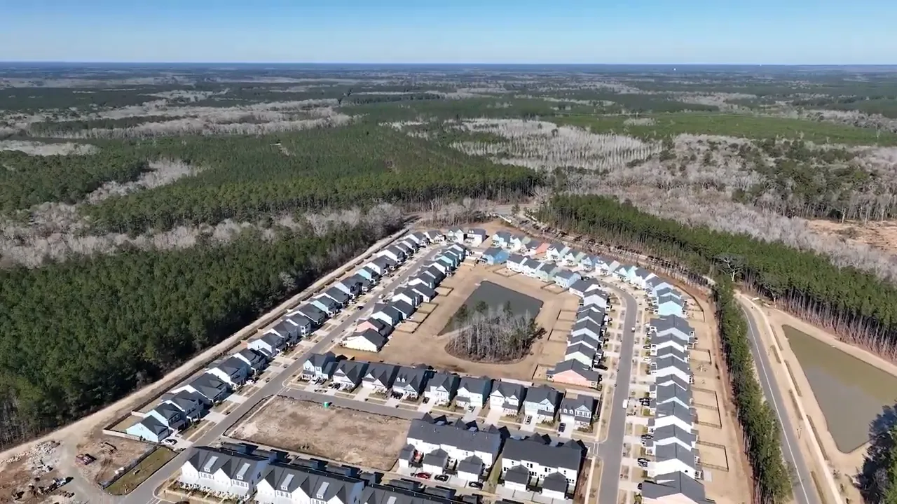 Aerial view of Homecoming streets surrounded by wooded land