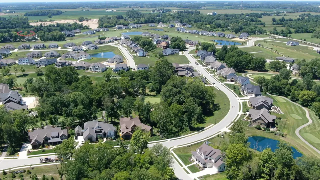 Aerial view of Westfield Indiana suburban neighborhoods along a curving road