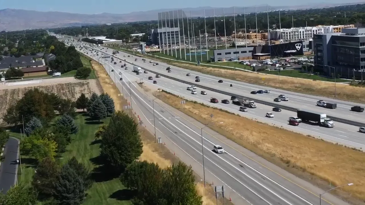 Baker decorating a pastel drip cake in a commercial kitchen representing a local small business