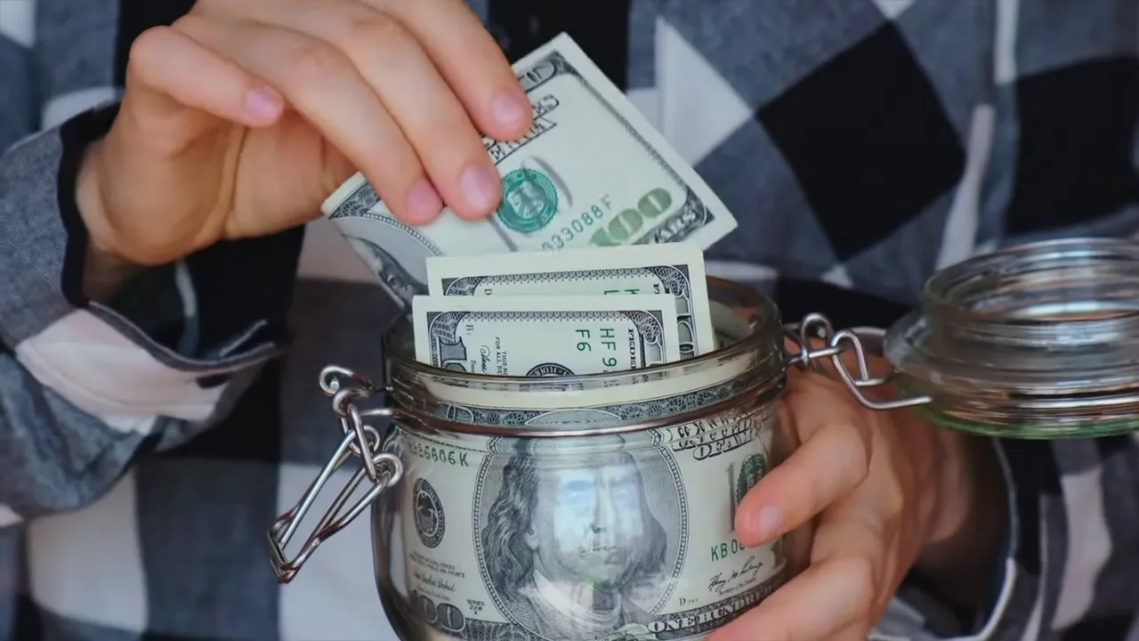 Presenter seated in a home studio delivering a market update with colorful backlighting