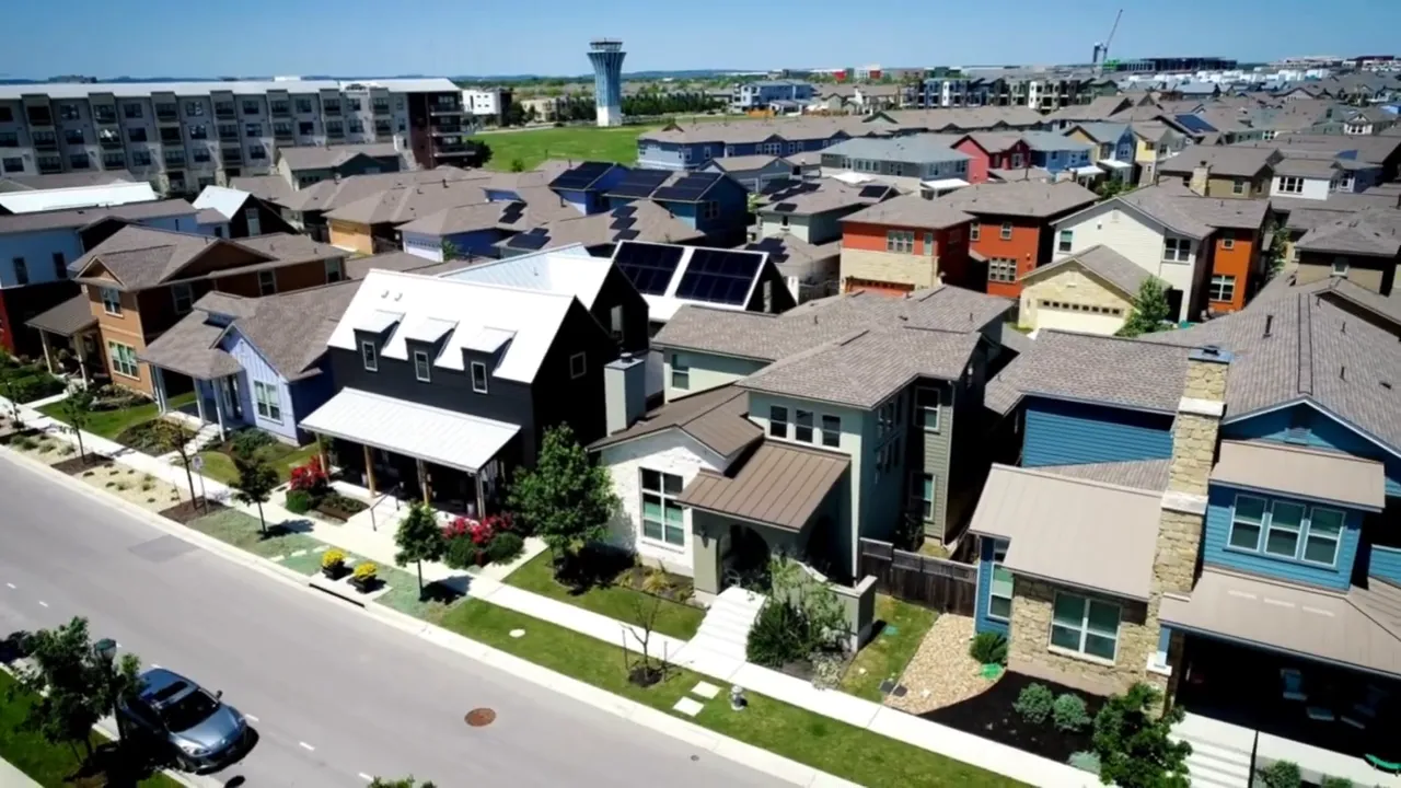 Two hosts on a studio set; the host on the right gestures while explaining market hesitation, with microphones and a laptop visible.