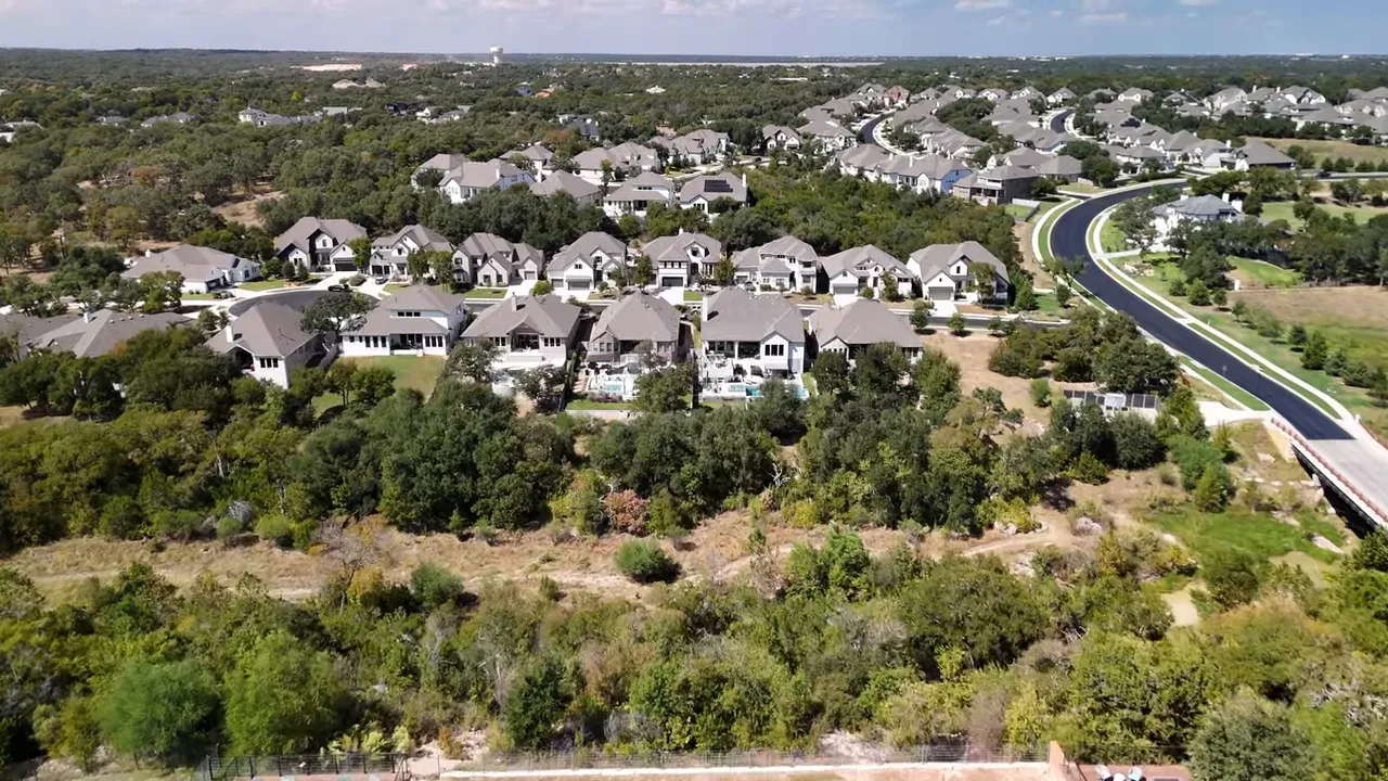 Two presenters sitting side-by-side in a living room speaking to camera with no on-screen overlays
