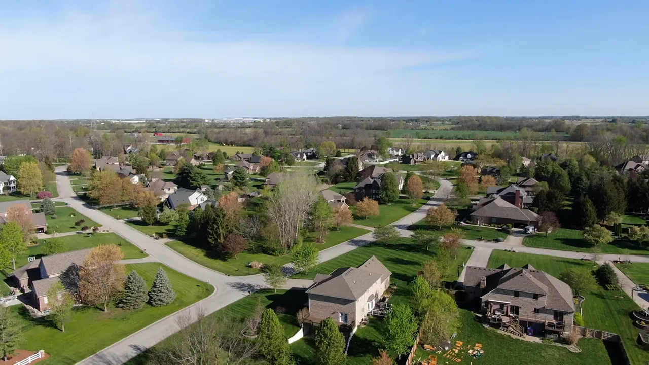 Aerial view of suburban homes with on screen words Location and Price Range