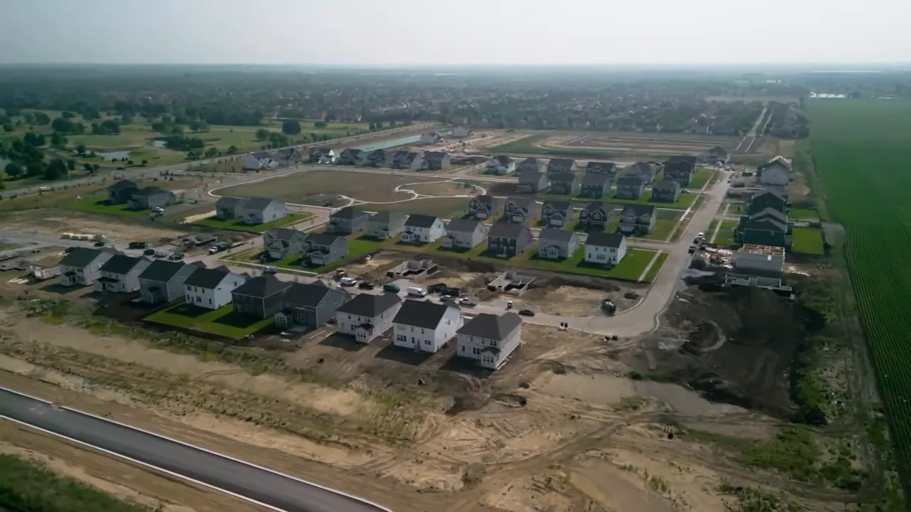Host in studio with on-screen text 'taxes and insurance are both up' over a wood-slat background and shelf of collectibles.