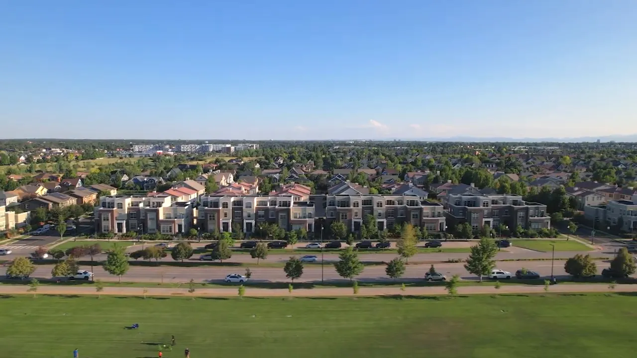 Aerial neighborhood view with text saying pending home sales are down