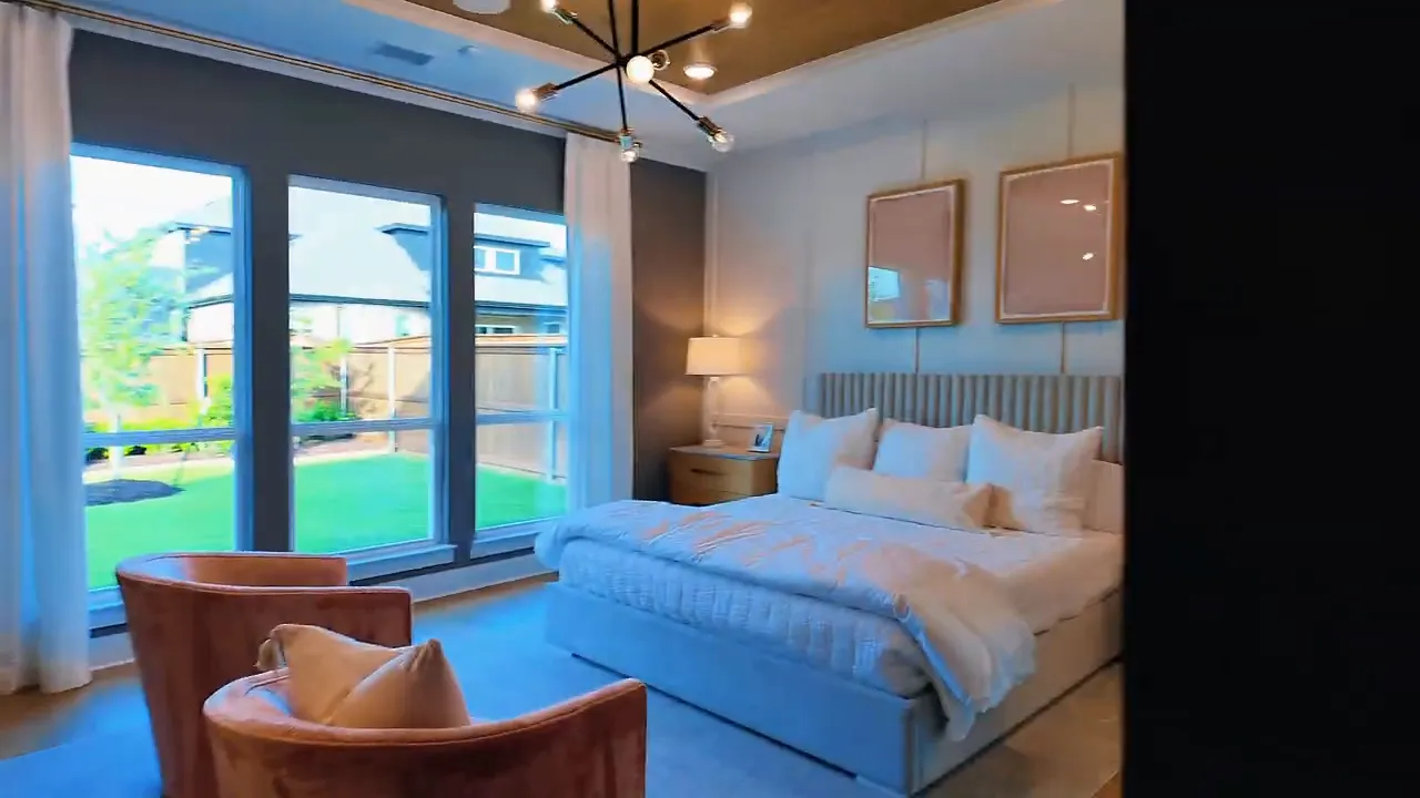 Staged bedroom with wall art and bedside table in a Forney TX new construction home