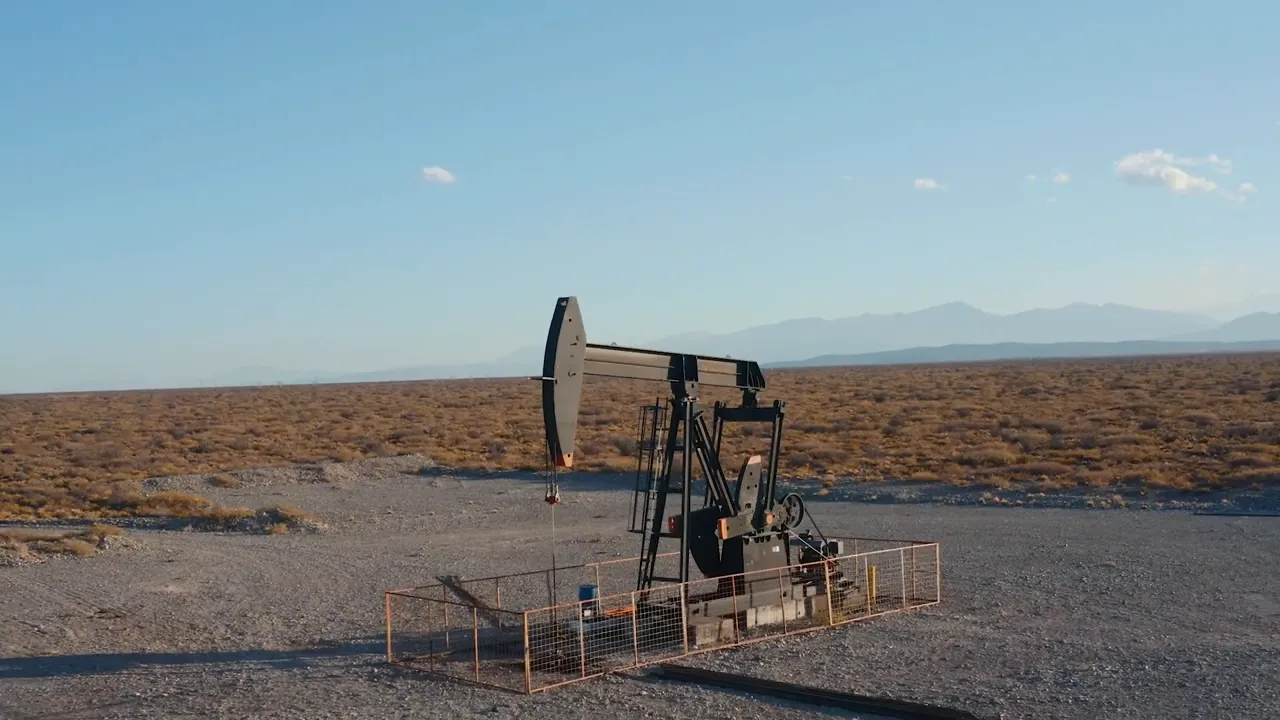 Two men standing in tall grass on a parcel of land, discussing deed restrictions and land use.