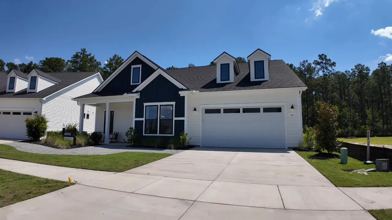 Blue and white two story model home with wide driveway