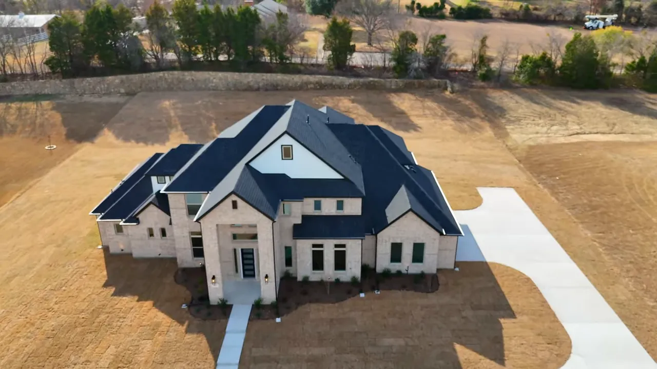 Wide aerial of Las Brisas at Stoney Creek showing full-acre residential lots, streets and a lake