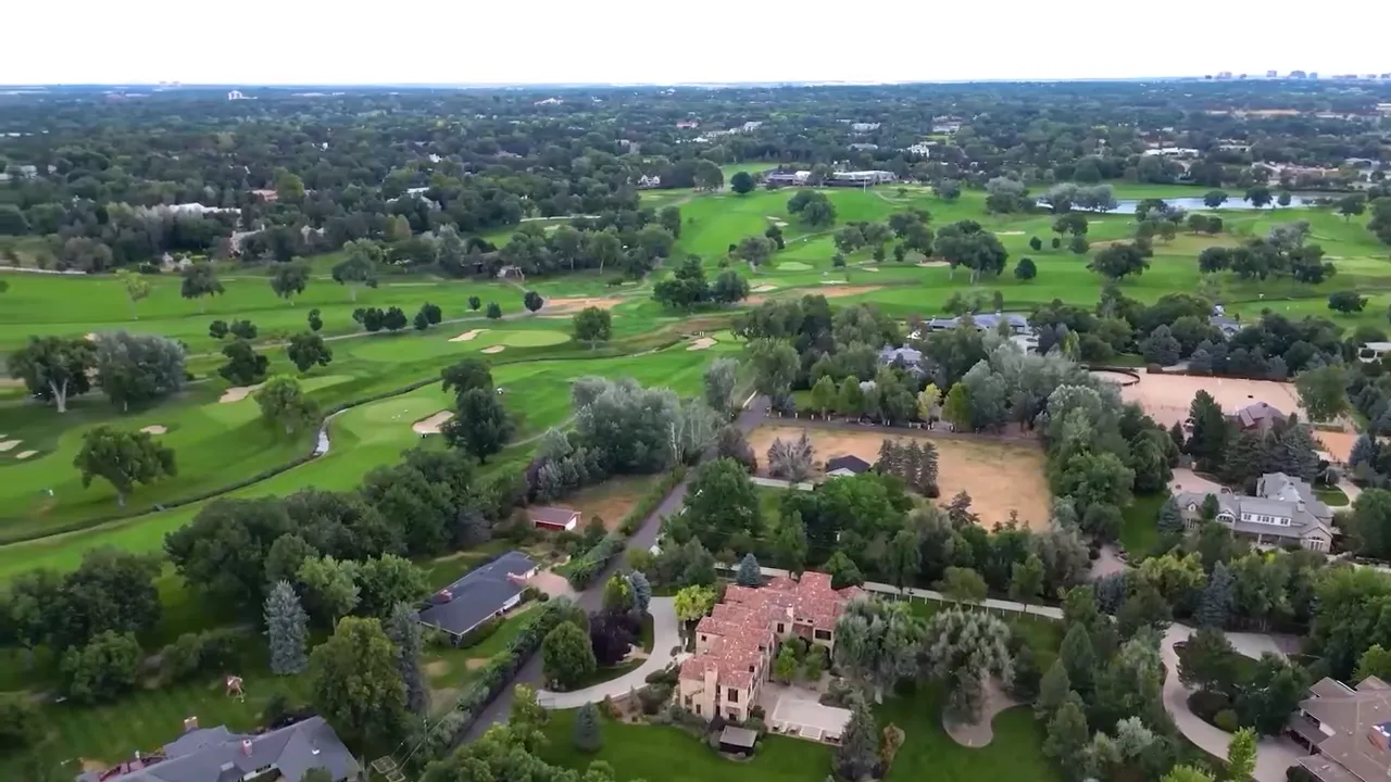 Real estate presenter speaking outdoors near a green landscape in the Denver area