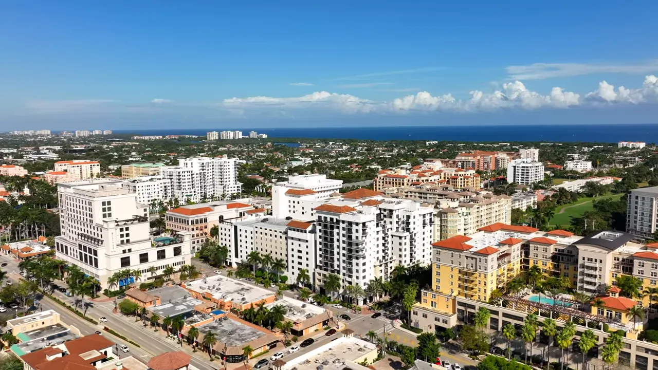 View down a residential street in Palm Beach Farms, Boca Raton with palm trees and single-family homes