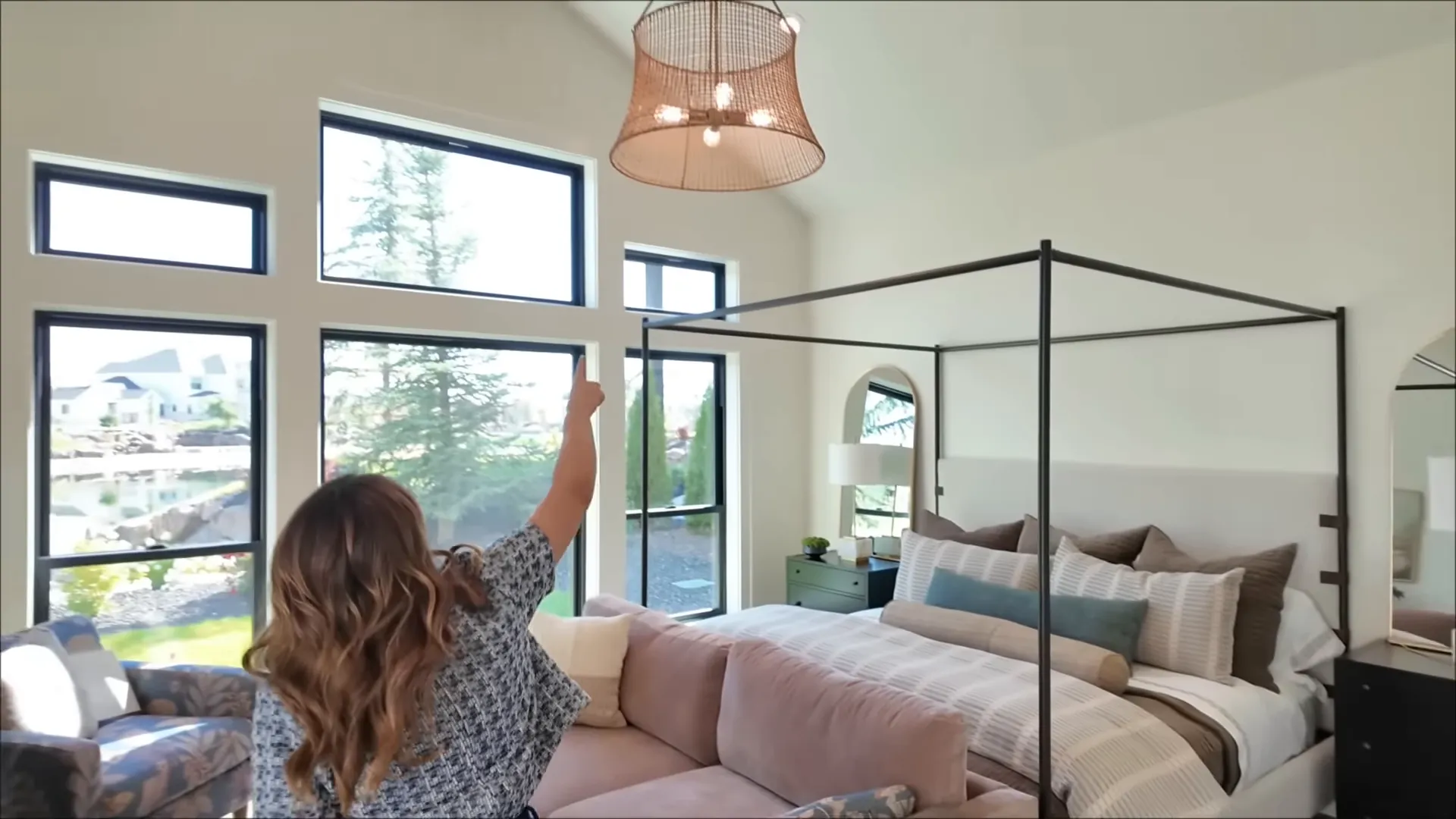 Primary bedroom with large windows overlooking the water