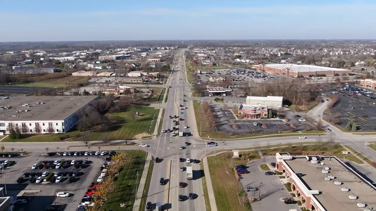 Close-up of rainwater pooling and rippling on paving stones after a shower.