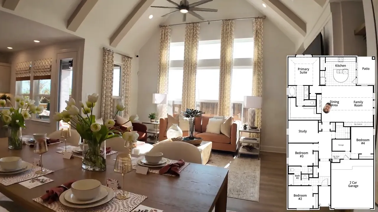 Vaulted living room with exposed beams, tall windows, dining table in foreground and a horseshoe-style island; small floor plan overlay at right.