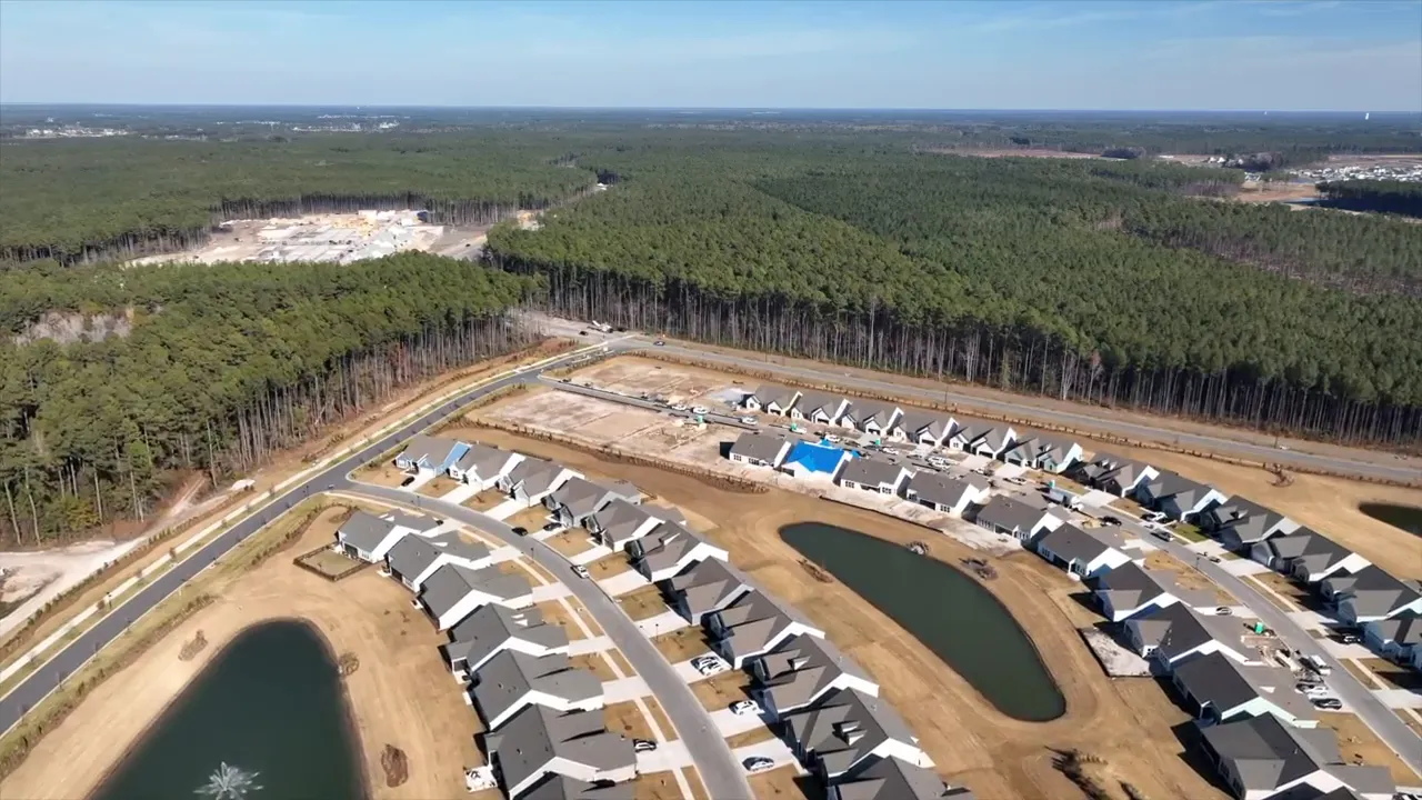 Aerial view of a large new housing development with text reading number five neighborhood growth