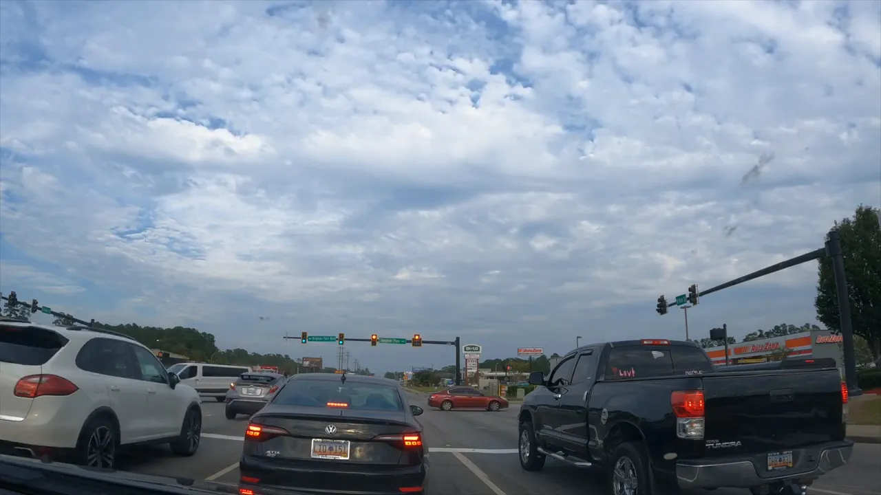 Busy multi lane intersection with cars waiting at a light and text reading number four traffic