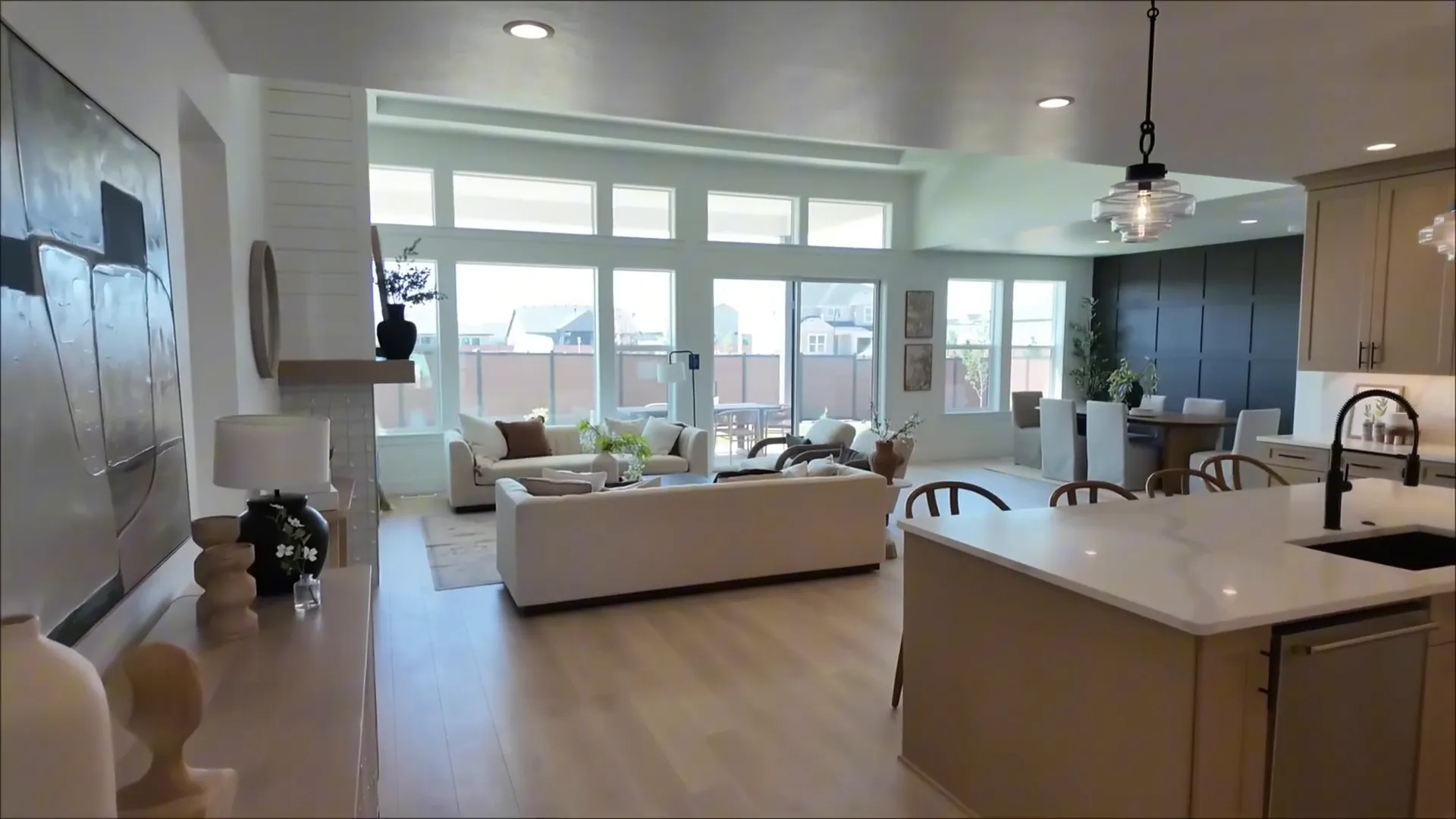 Living room flooded with natural light and tall windows