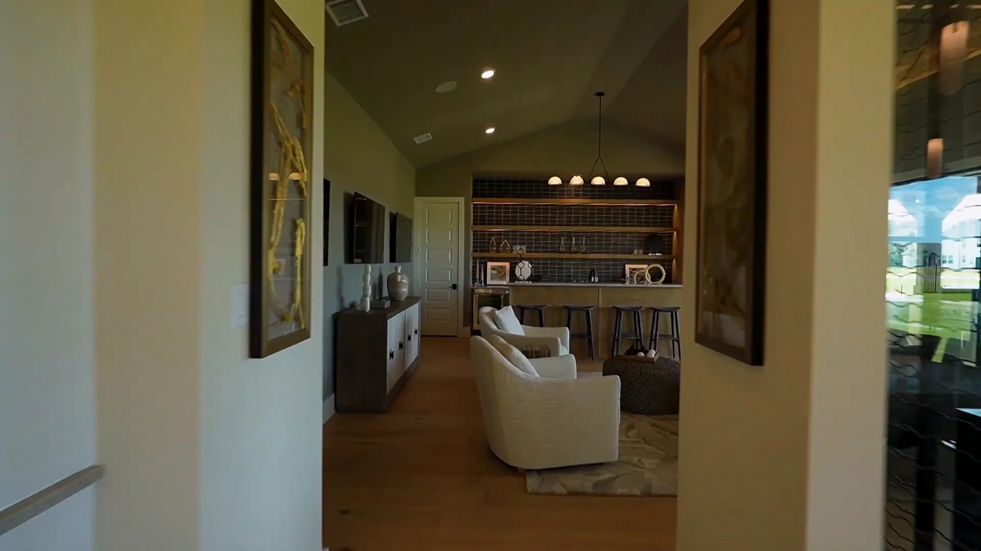 All-glass wine room separating dining and entertainment areas