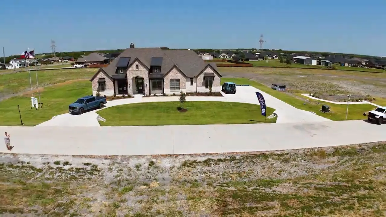 Aerial view of the Victoria model home with front lawn and circular driveway