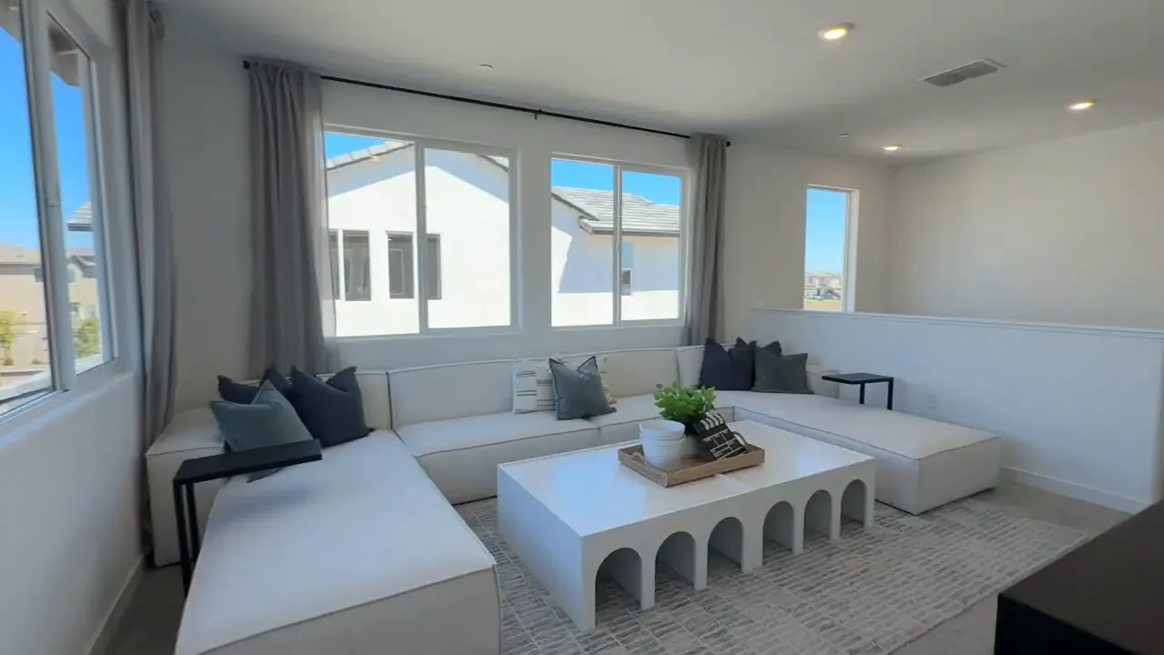 Upstairs secondary bedroom corner seating area with large windows in Arbor Ranch home Residence 2793
