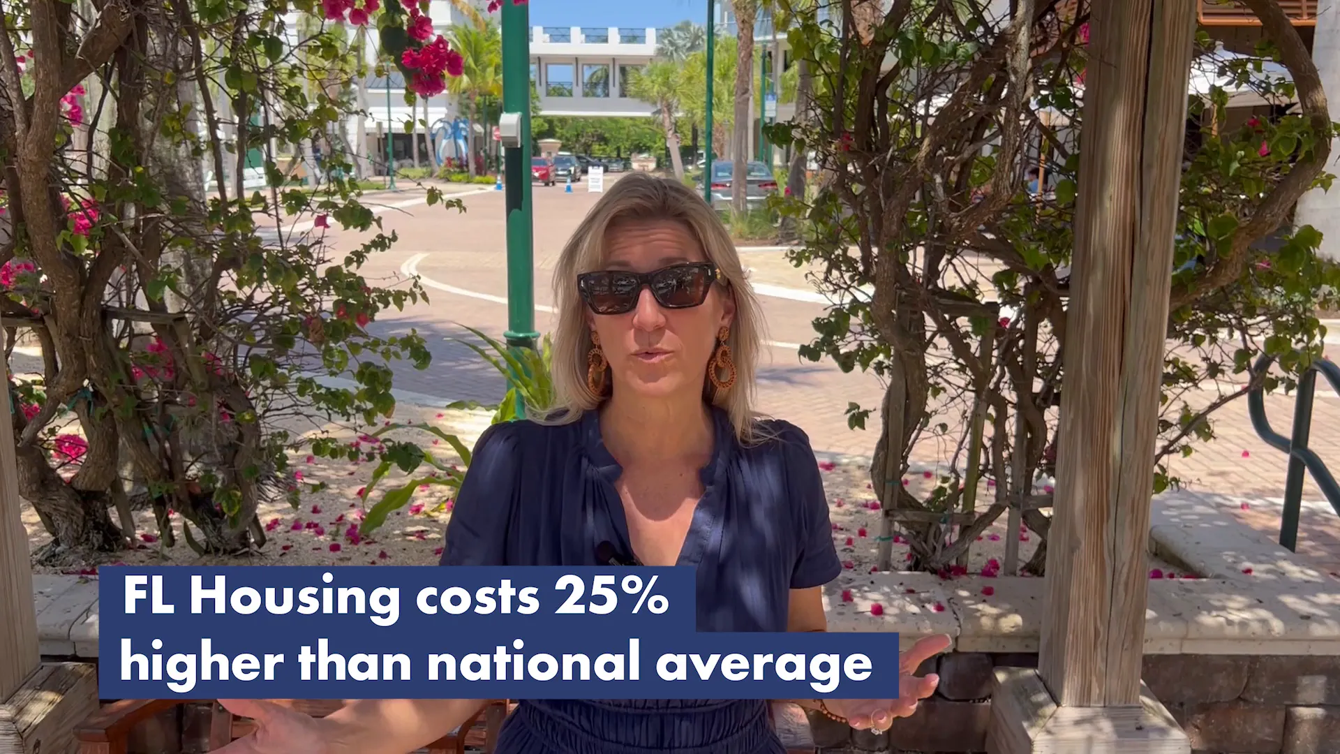 Presenter on-location with an on-screen overlay reading 'FL Housing costs 25% higher than national average'