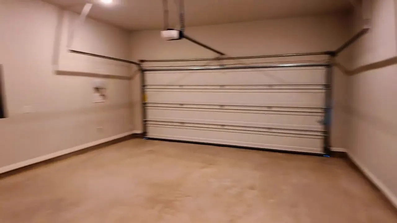 Garage wall with electrical panel and utility components in a new construction home near Dallas, Texas