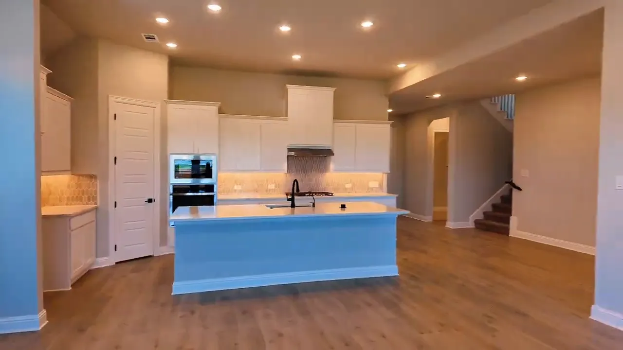 Electric fireplace in the living room with view into the kitchen