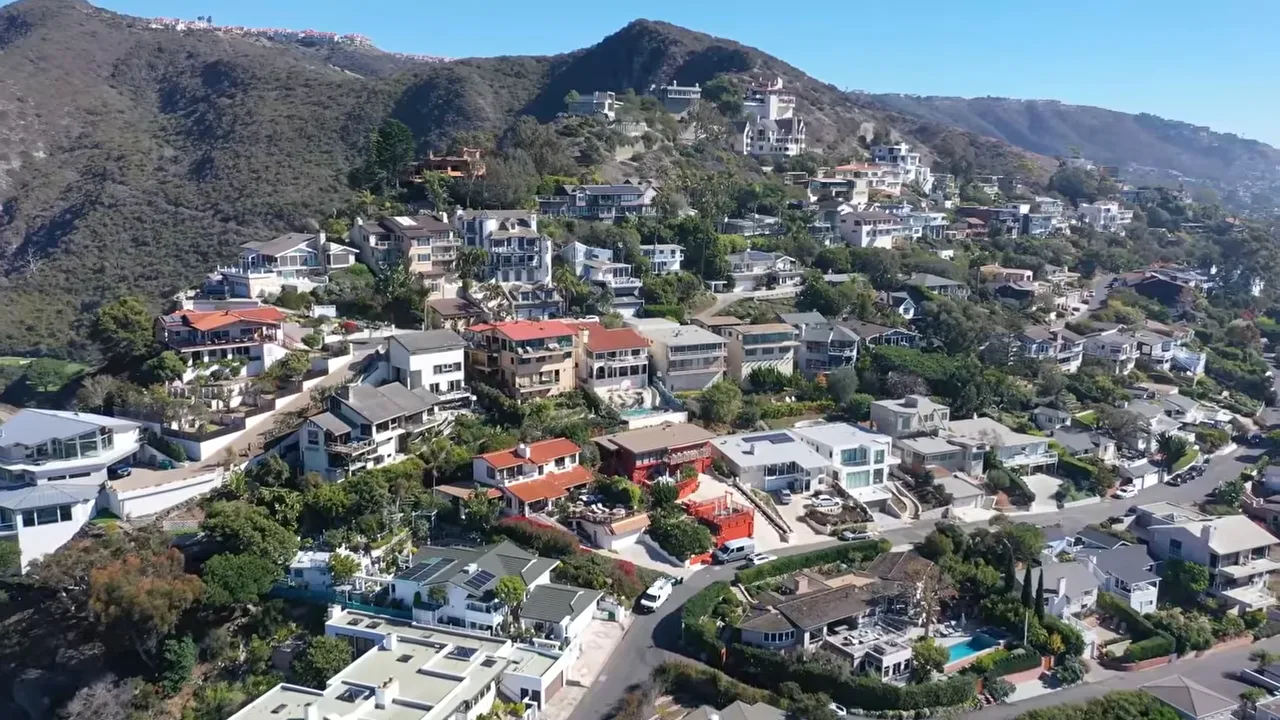 Hillside homes with overlay labels showing closing costs and moving costs