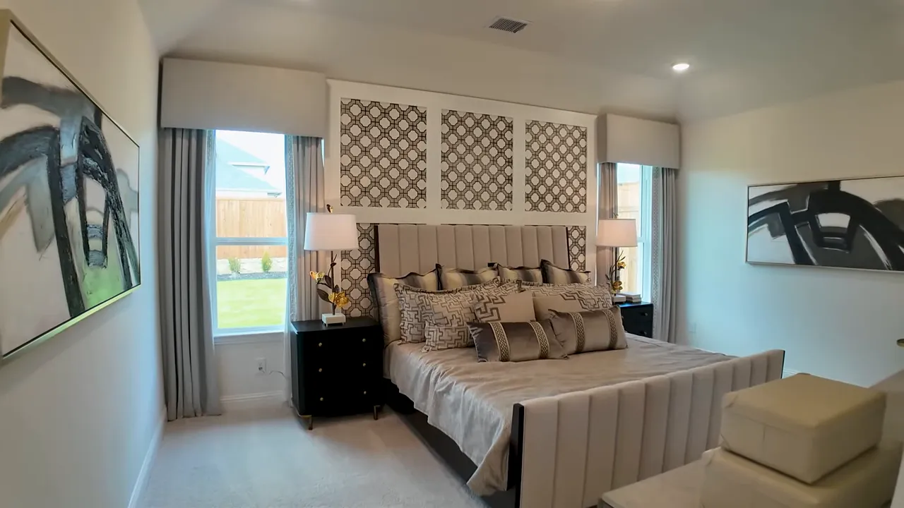 Primary bedroom with framed windows and high ceiling detail