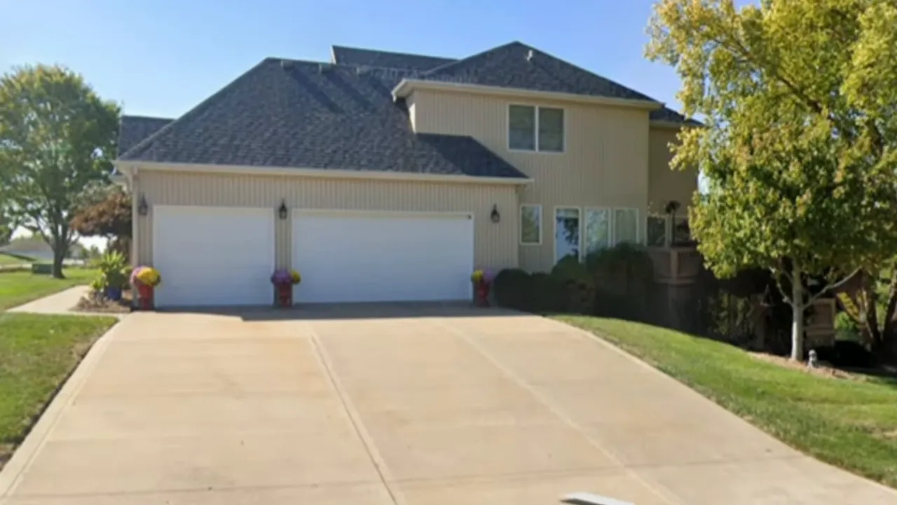 brick front home with covered entry and brick mailbox along the street