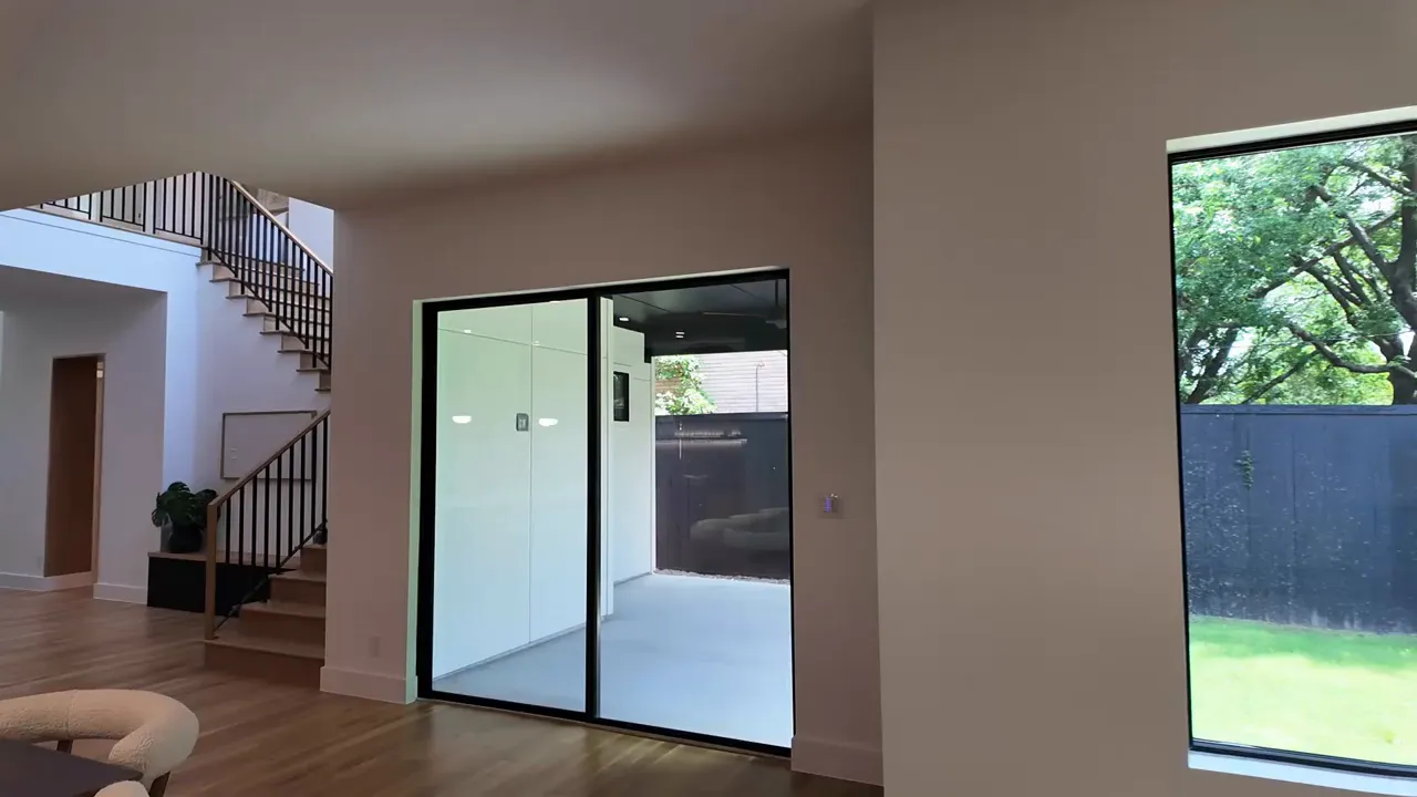 Dallas luxury home interior with large sliding glass doors to backyard