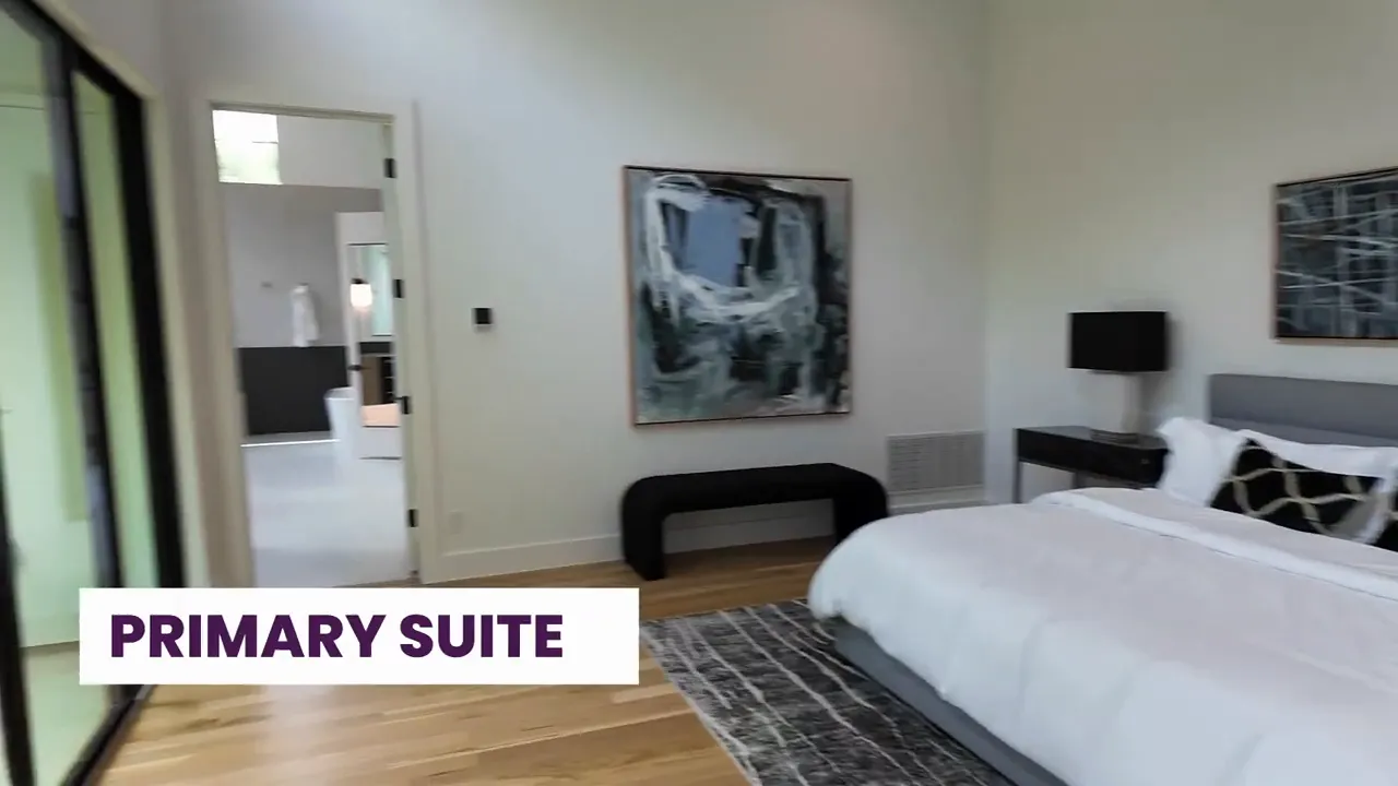 Staged primary suite bedroom with bed, nightstands, and modern wall art