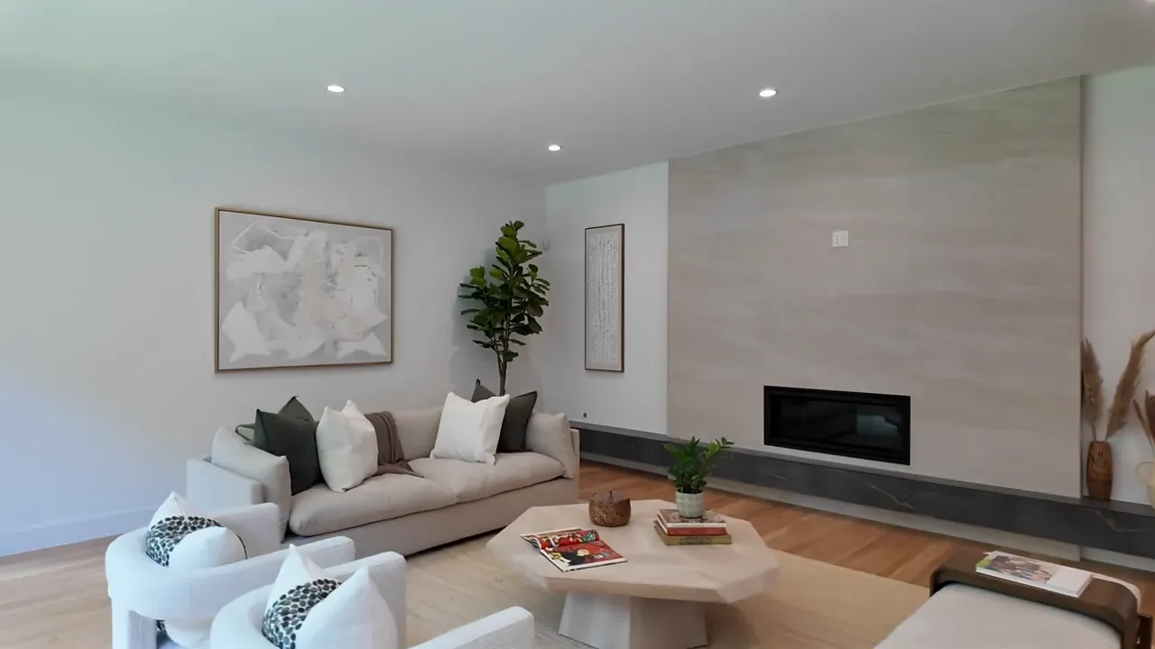 Open-concept living room in modern Dallas luxury home with minimalist fireplace wall
