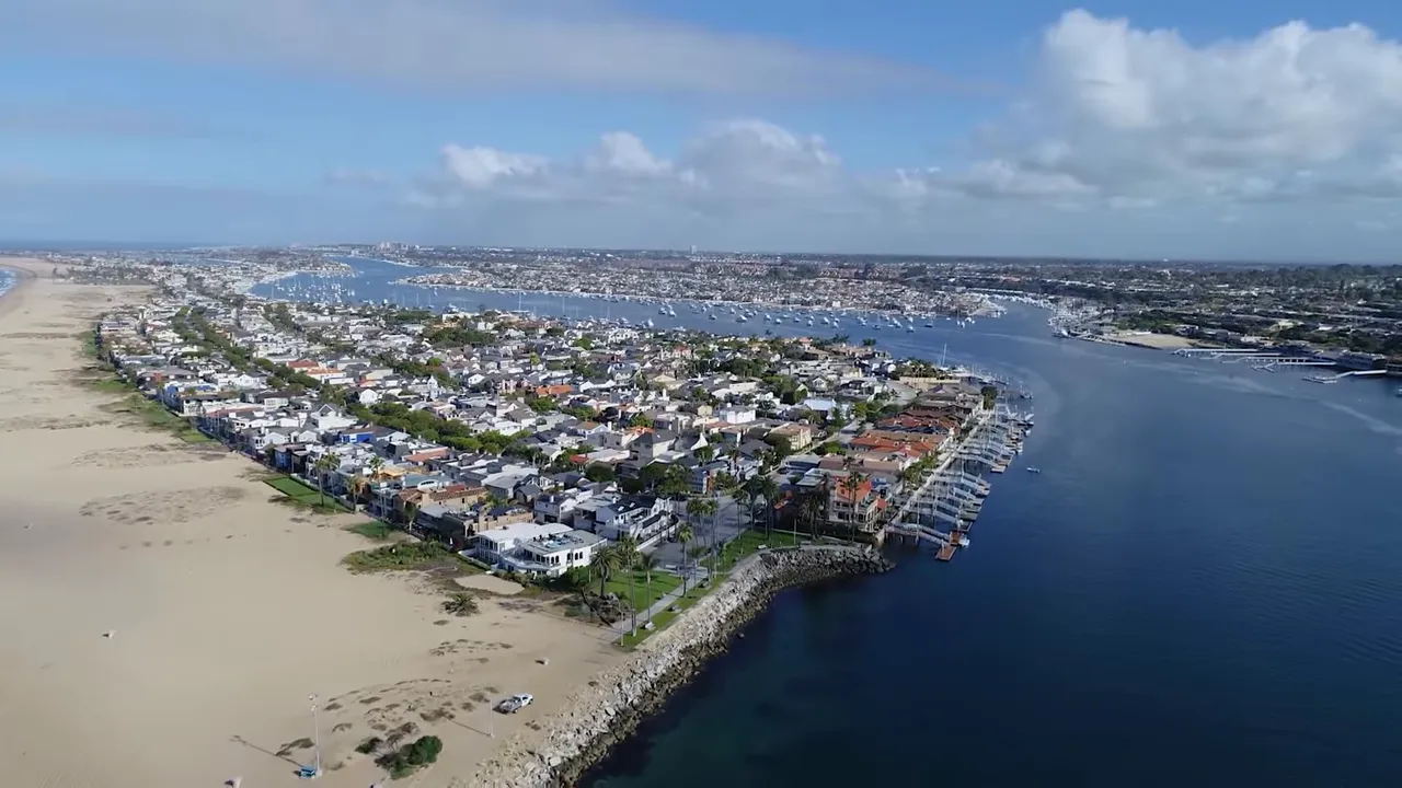 Aerial coastal view of Newport Beach shoreline and surrounding neighborhoods